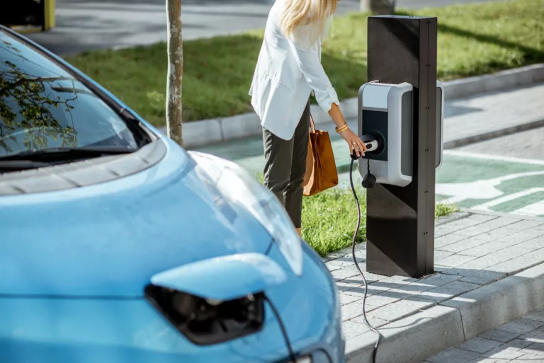 Woman charging electric car